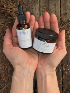Iremia Skincare oil and cream in hands