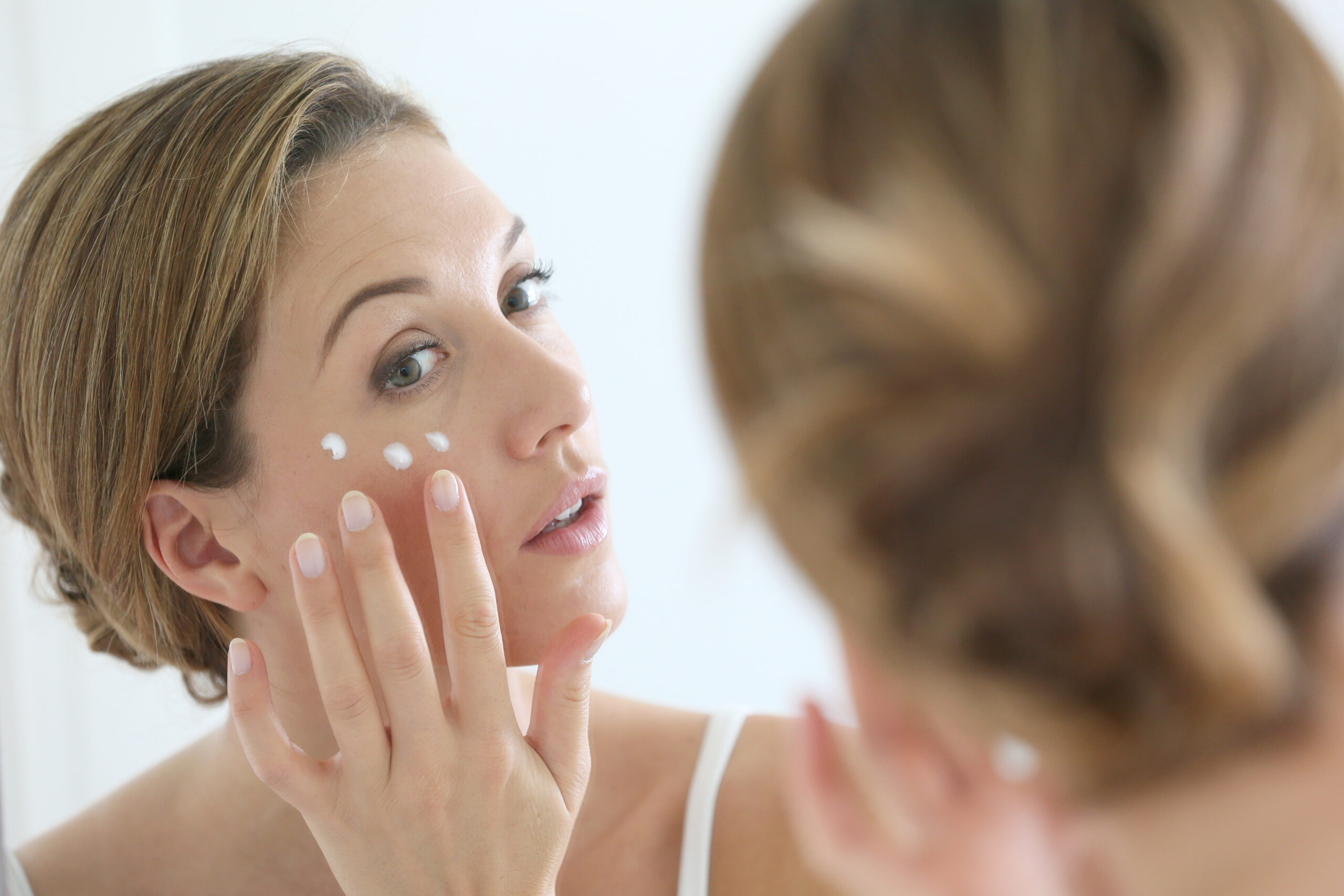 woman applying face cream